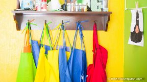 Bunte an der Wand hängende Kinderschürzen